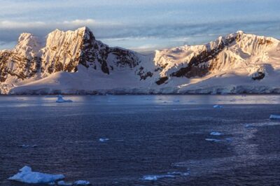 Snow-covered mountains and glaciers on an Antarctic bay
