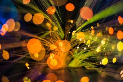 Illuminated fiber-optic strands for high-capacity communications