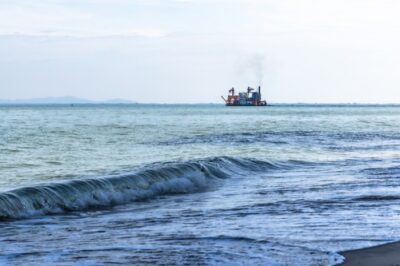 Cargo vessel offshore, illustrating a maritime route for the planned Kruger subsea cable system.