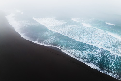 Aerial view of the Pacific coast and black volcanic sand in Kamchatka, Russia