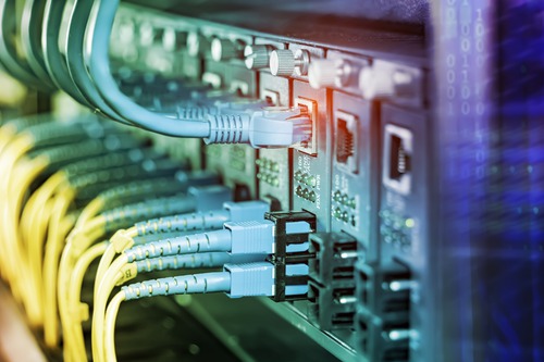 Fiber-optic and network cables connected in a data-center rack