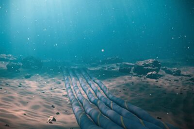 Subsea fiber-optic cable bundles on the ocean floor, illustrating UK cable security policy